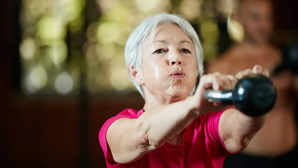 Toning Arms Without the Bulk: Is It Achievable? 1 Woman doing resistance band exercises for toned arms Salisbury